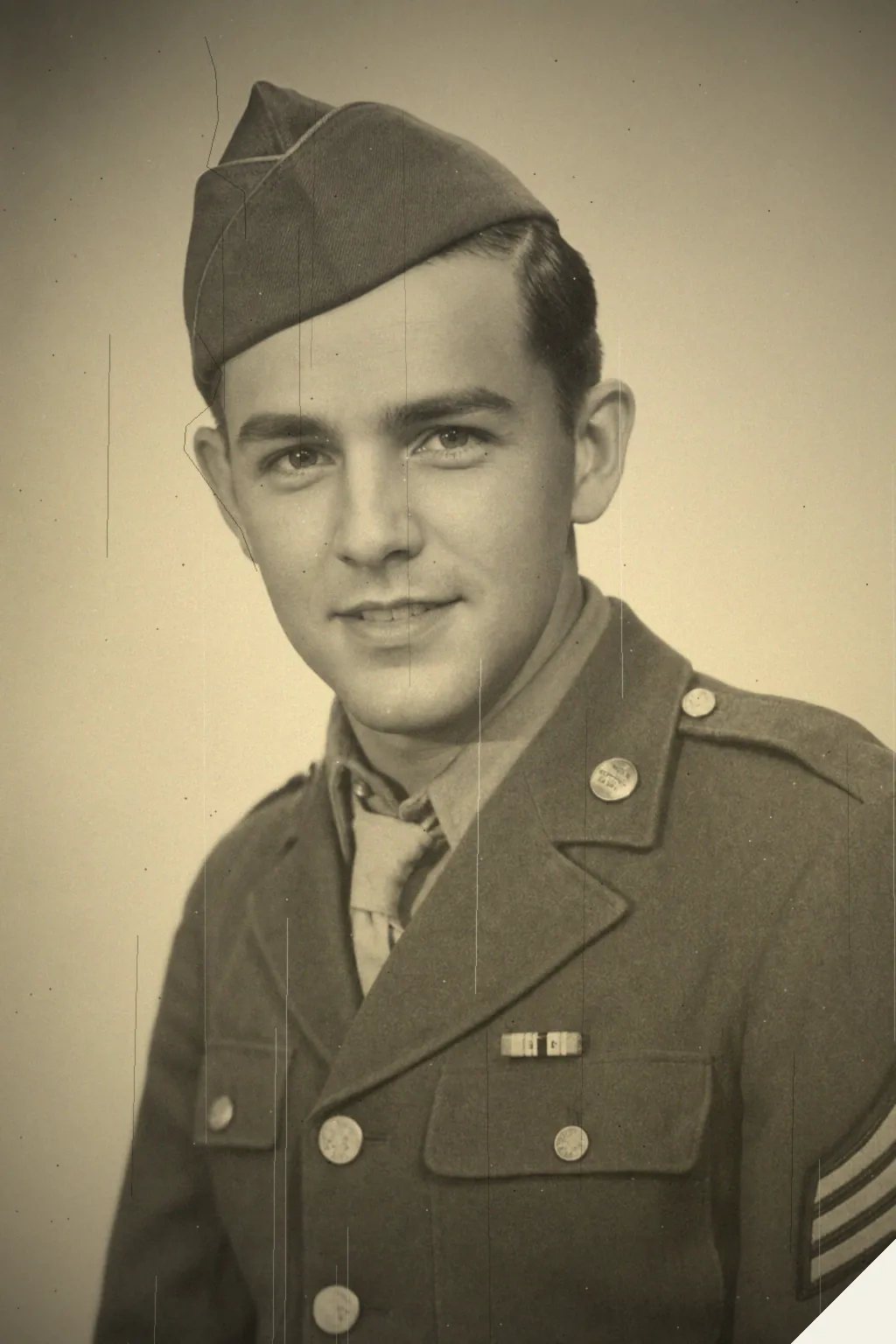 The same soldier portrait before restoration, torn and scratched