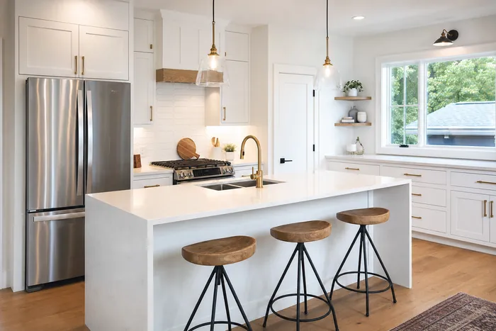 A bright, balanced real estate photo of a white kitchen
